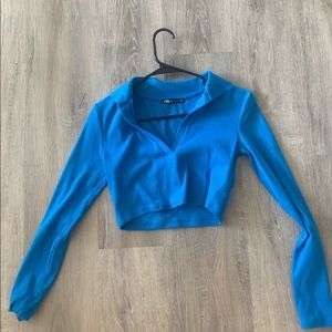 Small blue long sleeve crop top.